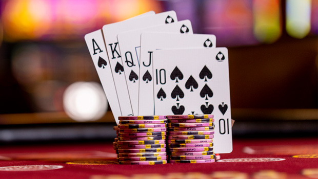 playing cards standing up next to a stack of poker chips